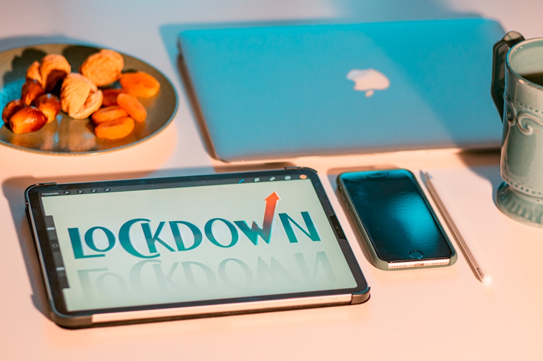 silver macbook beside blue and white ipad case
