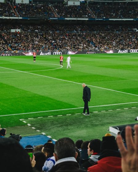 people watching soccer game during daytime