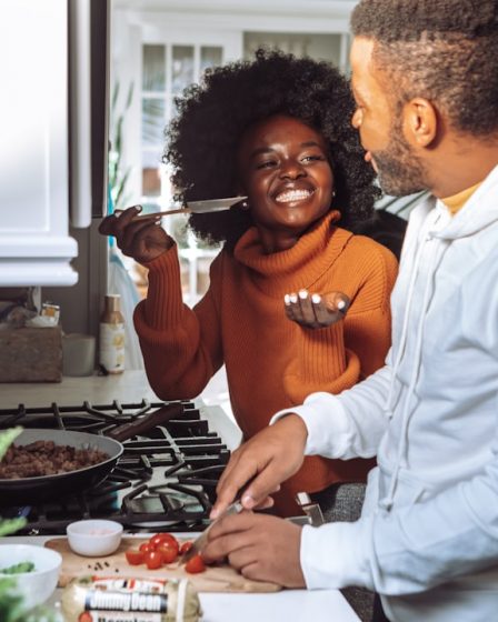 man in white dress shirt holding a woman in brown long sleeve shirt