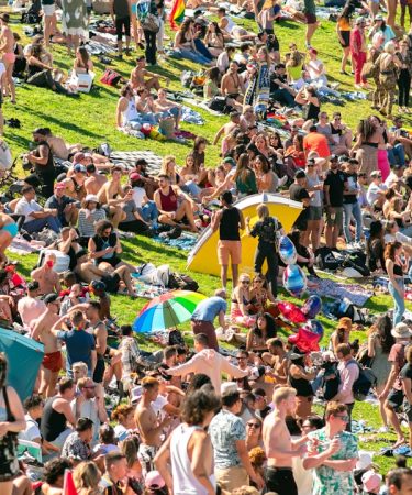 people sitting on green grass field during daytime