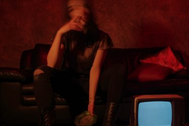 a woman sitting on a couch in front of a tv