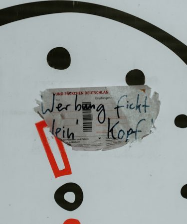 a close up of a clock with a piece of paper on it