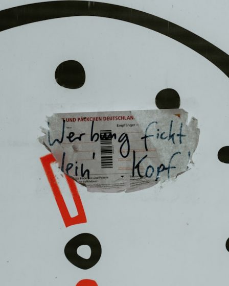 a close up of a clock with a piece of paper on it