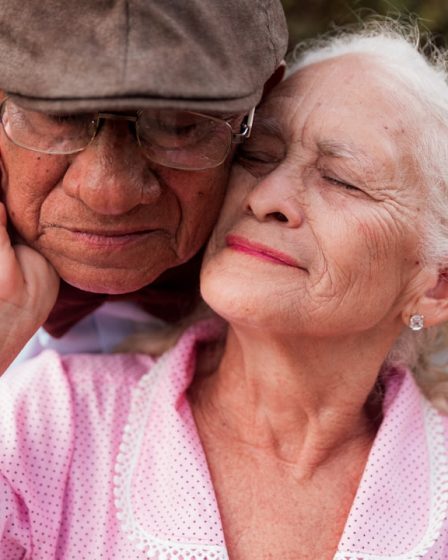 An older couple is embracing each other