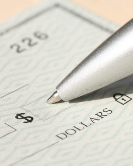 Pen poised over a check, ready to write