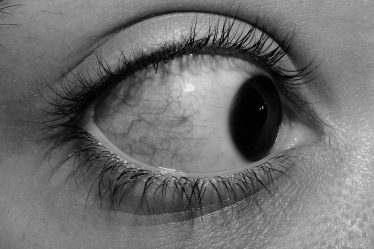a black and white photo of a person's eye