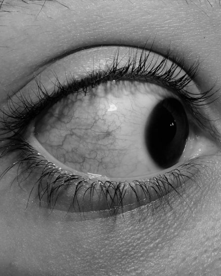 a black and white photo of a person's eye
