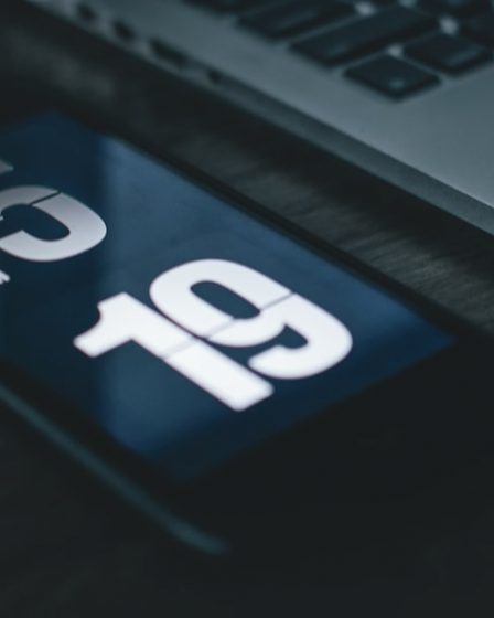 black smartphone beside laptop