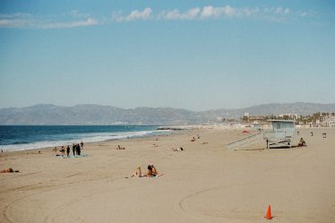 People relaxing on a sandy beach with ocean waves