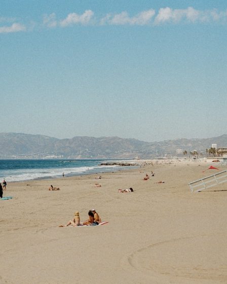 People relaxing on a sandy beach with ocean waves