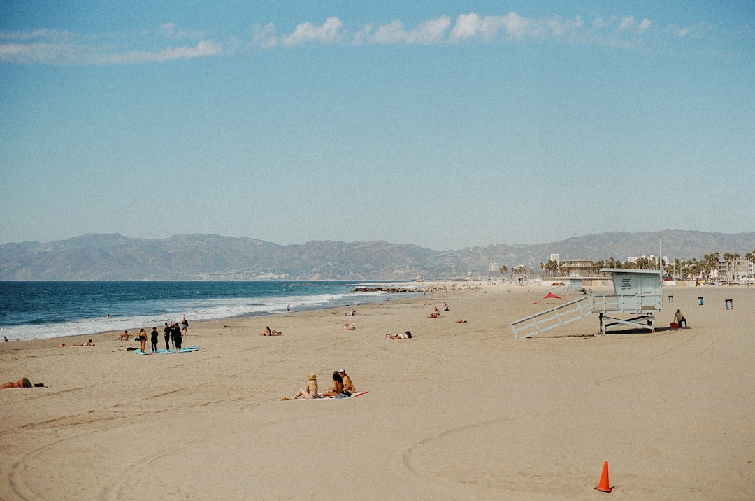 People relaxing on a sandy beach with ocean waves