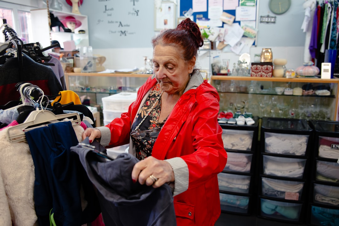Elderly woman sorting clothes in a store