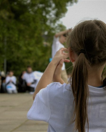 A young girl watches a street performance