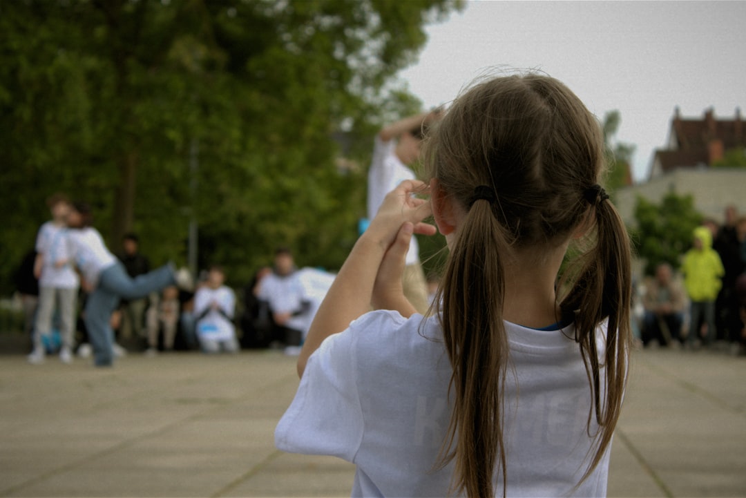 A young girl watches a street performance