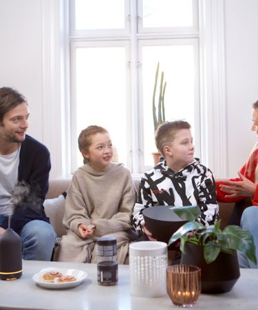 a group of people sitting on top of a couch