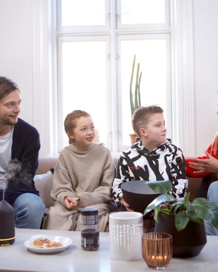 a group of people sitting on top of a couch