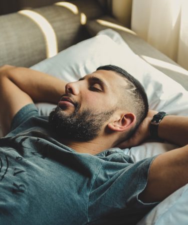 man lying on bed
